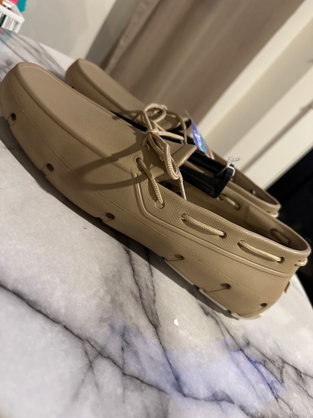 Tucket Giller boat shoes, a type of water-resistant deck shoes with drain holes